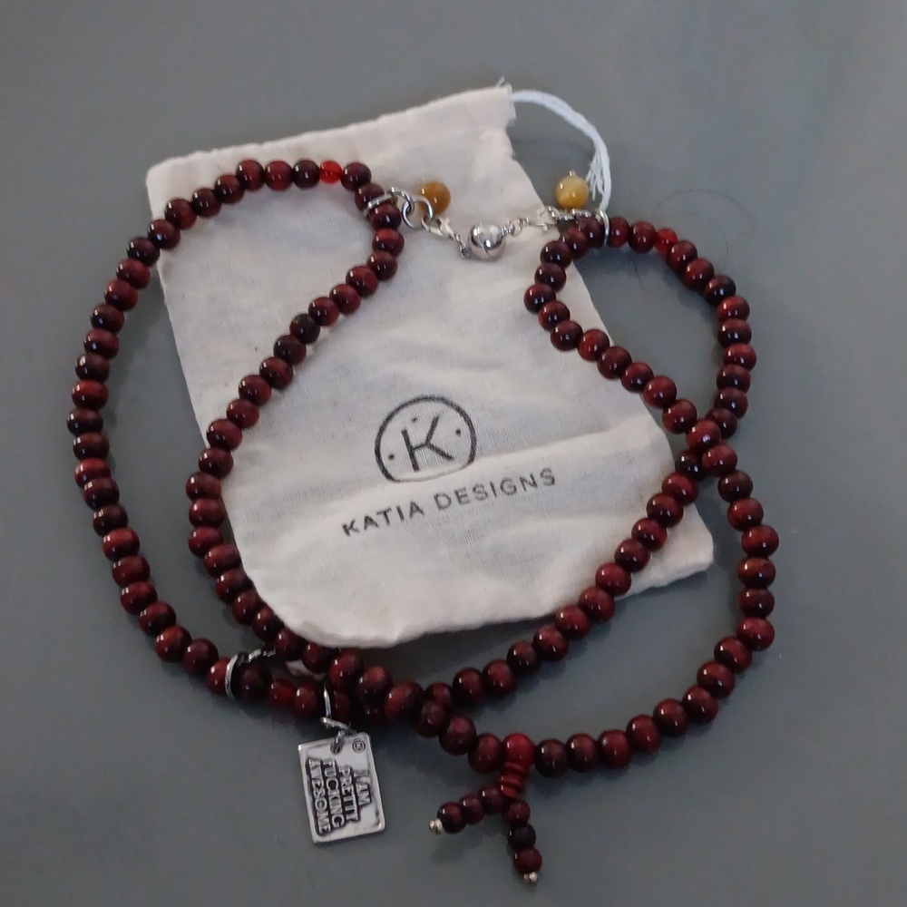 Katia designs red beaded necklace with tag saying I AM PRETTY F-CKING AWESOME